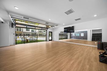 Yoga room with garage doors to outside